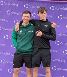 Two students in front of an Active Stirling banner