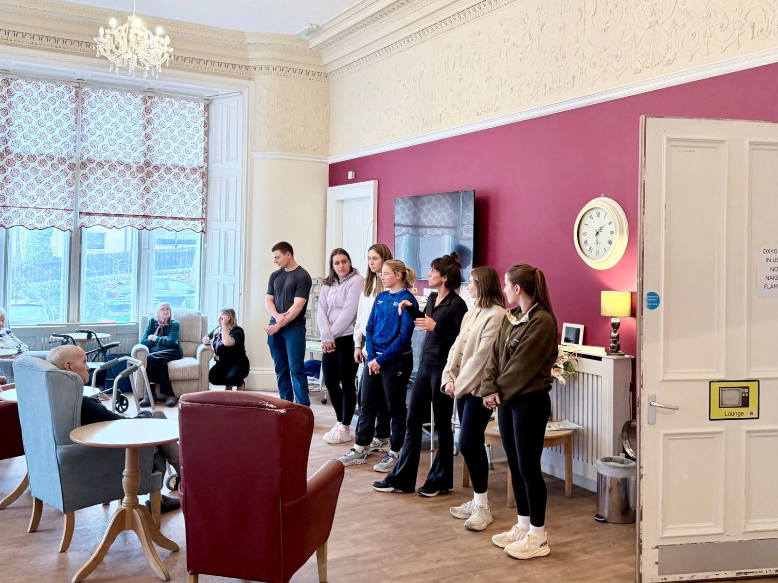 Students and staff leading a falls awareness session with residents in the lounge at Thorntree Mews Care Home
